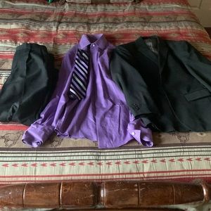 Black dress pants, purple dress shirt with purple tie, and dress coat